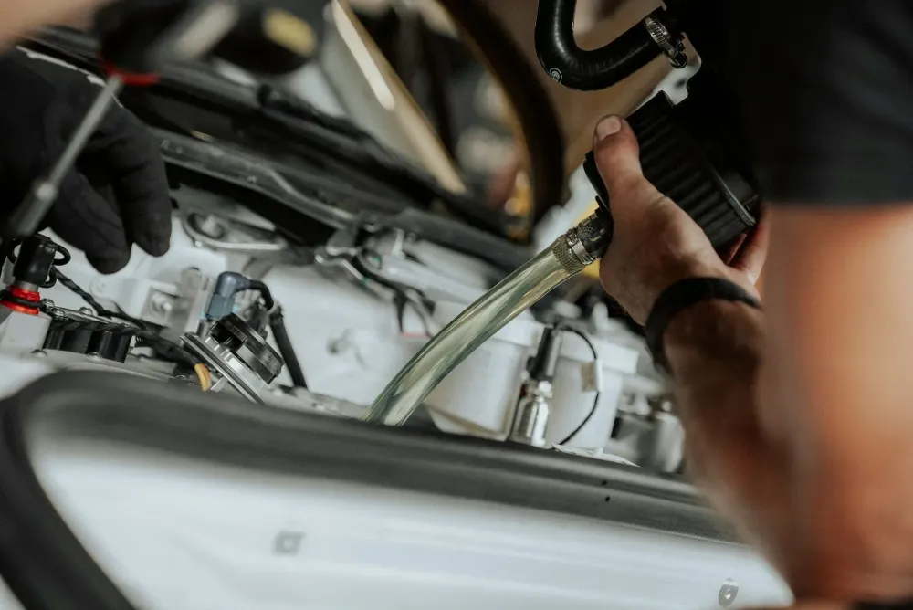 Checking engine oil before starting a long road trip on the highway.